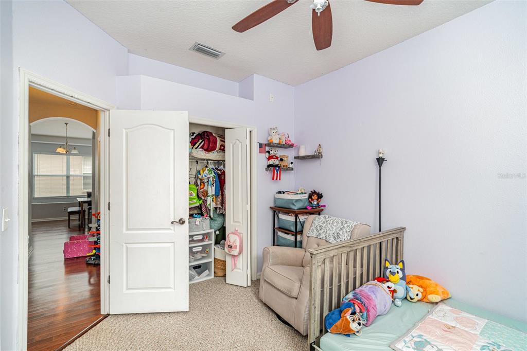 13612 Sigler Street Riverview, FL 33579 - Photo 24 of 31 a bedroom with furniture and a wooden floor