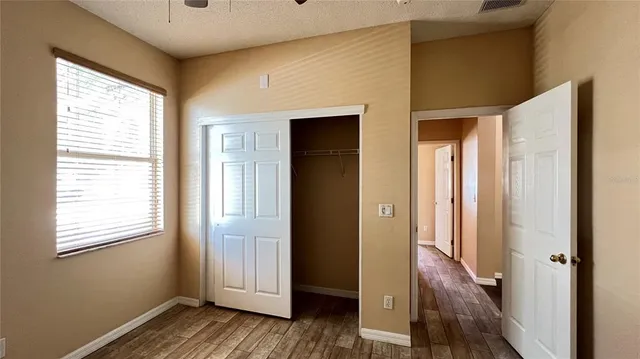 a view of room with a window and a ceiling fan