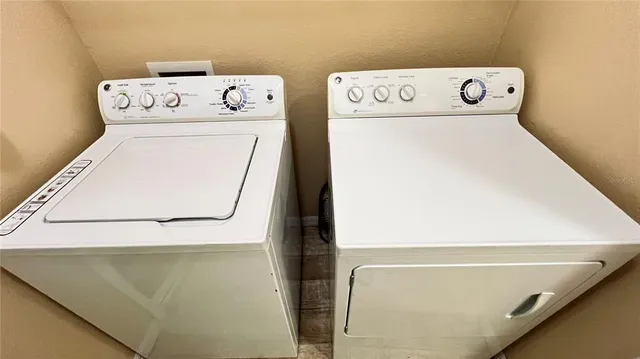 a view of a utility room with dryer and washer
