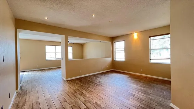 a large kitchen with stainless steel appliances a large counter top a stove and a refrigerator