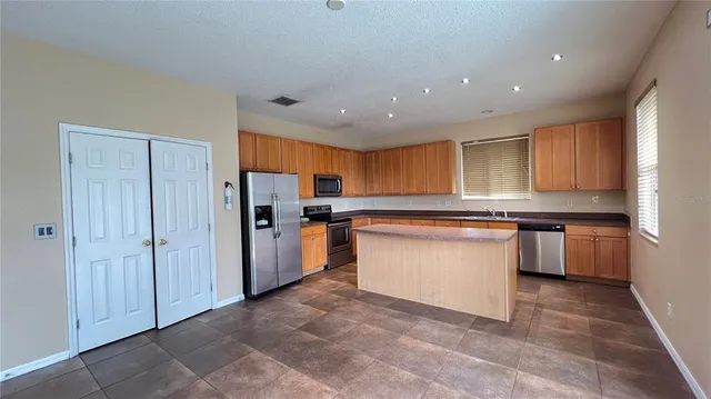 a view of a hallway with wooden floor and a living room