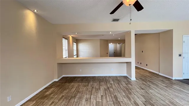 a view of empty room with a fireplace