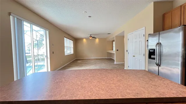 a kitchen with stainless steel appliances granite countertop wooden cabinets a stove top oven a sink and dishwasher a oven with wooden floor