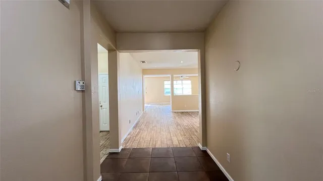 a view of a hallway view with wooden floor and staircase