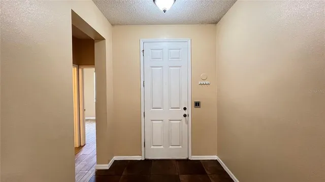 a view of front door with wooden floor