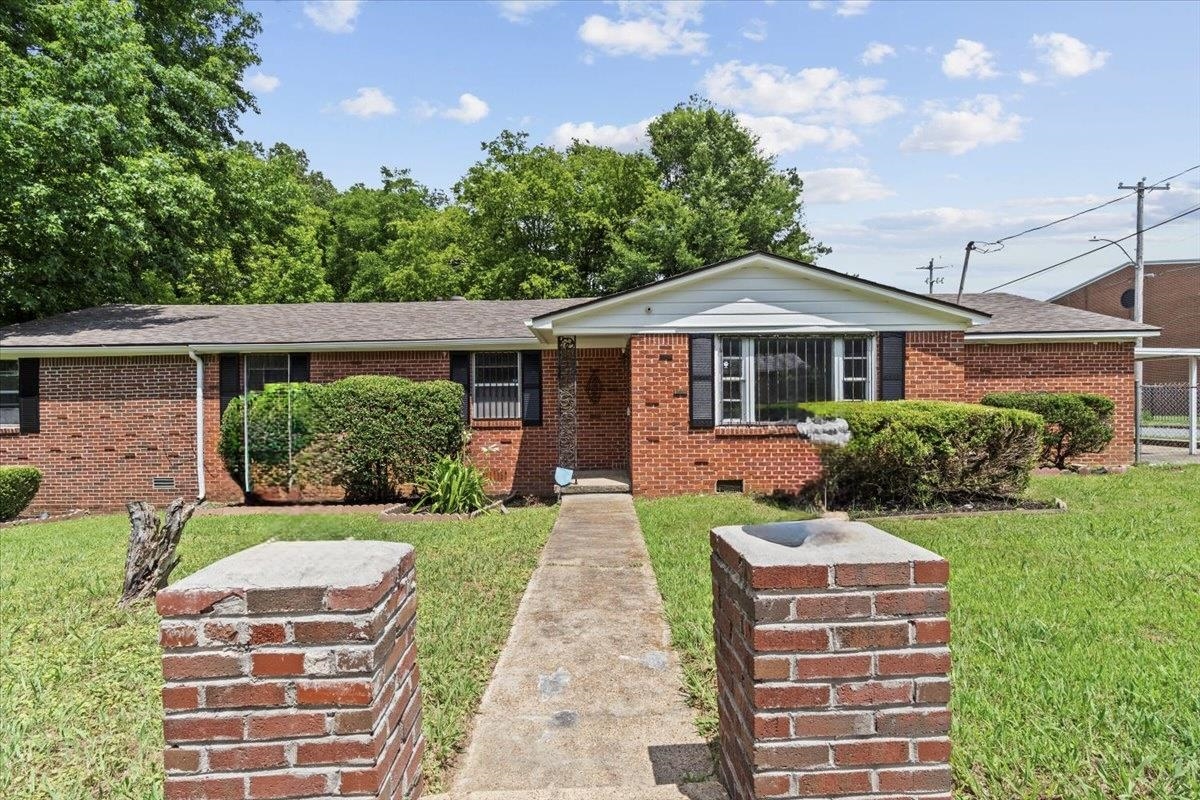 3590 Weaver Road Memphis, TN 38109 - Photo 1 of 23 View of front facade with a front lawn, brick siding, and crawl space