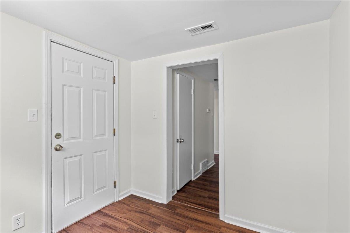 3590 Weaver Road Memphis, TN 38109 - Photo 15 of 23 Hallway featuring dark wood-type flooring and baseboards