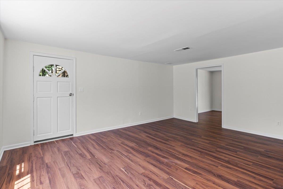 3590 Weaver Road Memphis, TN 38109 - Photo 8 of 23 Unfurnished room with dark wood-type flooring
