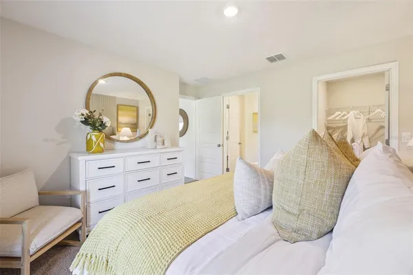 a bedroom with a bed and a dresser