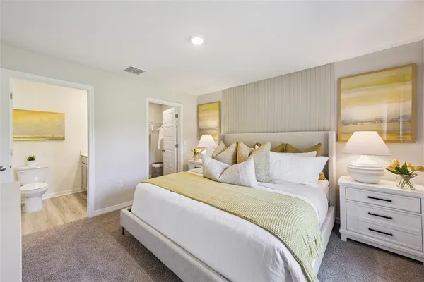 a bedroom with a bed and lamps