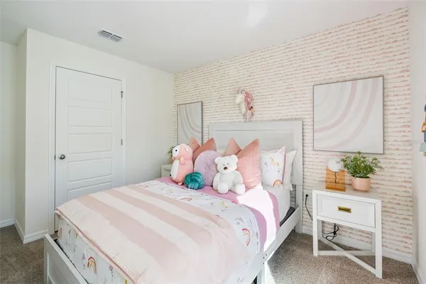 a bedroom with a bed and a table