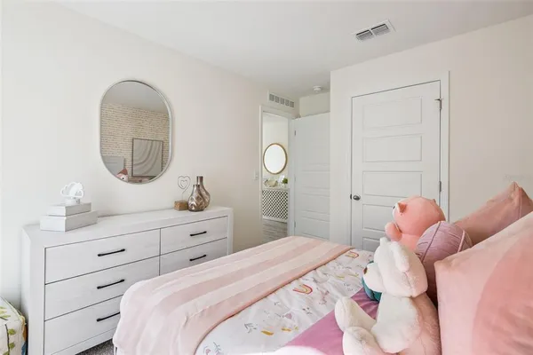 a bedroom with a bed and a dresser