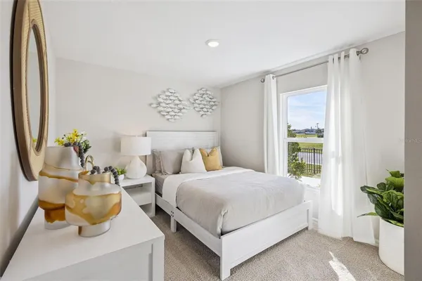 a bedroom with a bed and a potted plant