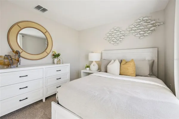 a bedroom with a large bed and a dresser