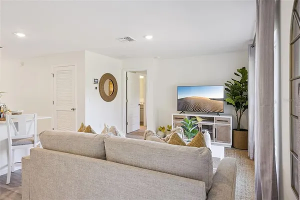 a living room with furniture and a clock
