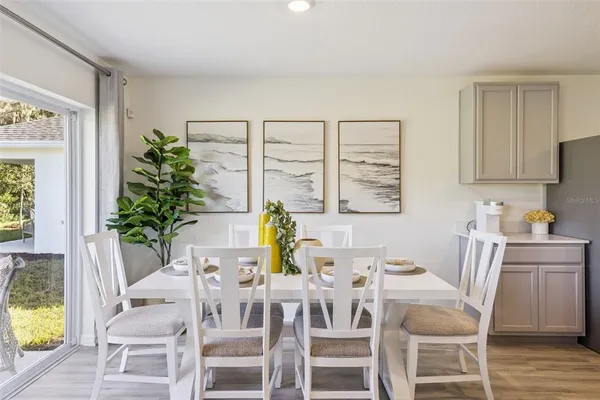 a view of a dining room with furniture window and wooden floor
