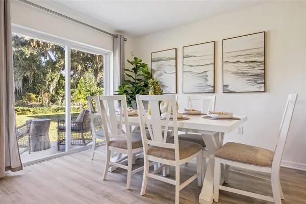 a view of a dining room with furniture window and wooden floor