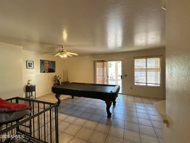 a kitchen with a table chairs refrigerator and cabinets