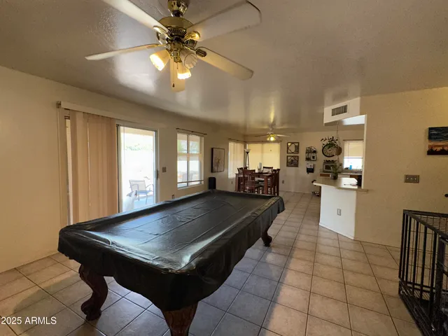 a room with lots of furniture and view of kitchen