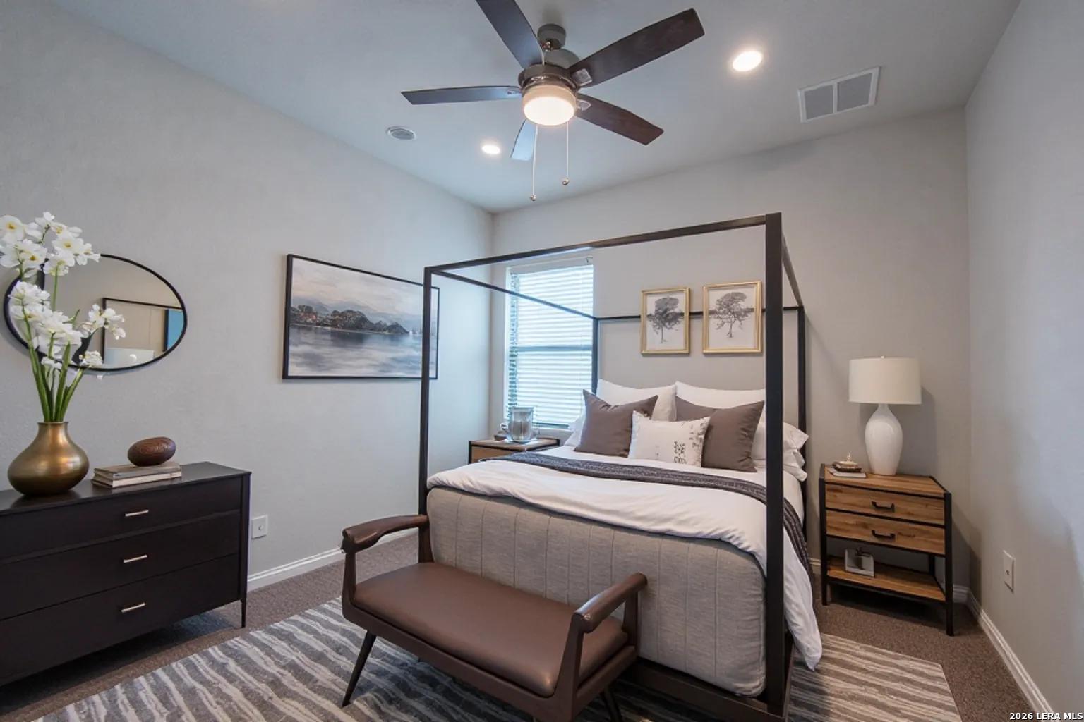 4947 Ranahan Pass St. Hedwig, TX 78152 - Photo 27 of 37 a bedroom with a bed and a chandelier