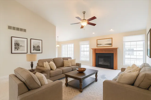 an empty room with windows and chandelier
