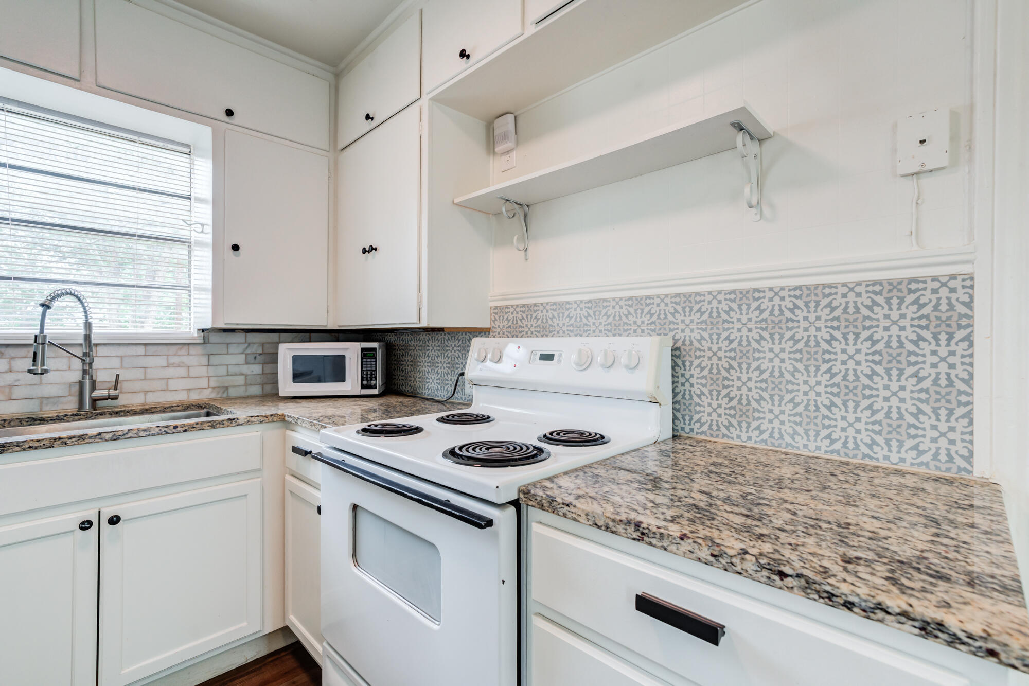 2308 30th Street Lubbock, TX 79411 - Photo 12 of 21 a kitchen with cabinets appliances and a counter space