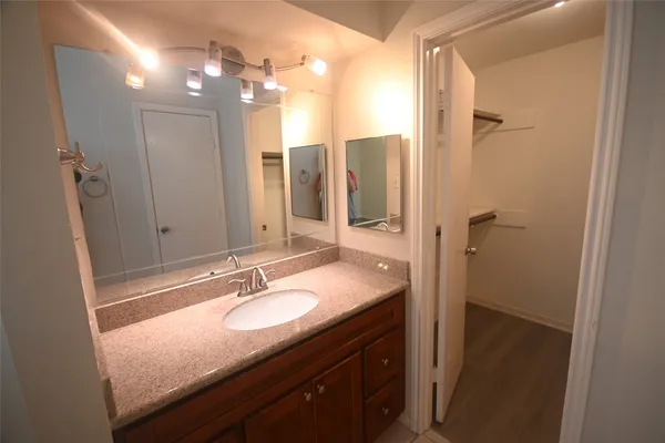 a bathroom with a sink a vanity and a mirror