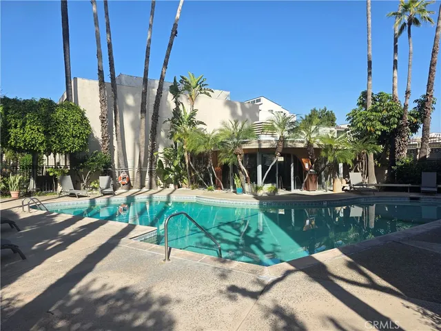 a view of a street with potted plants