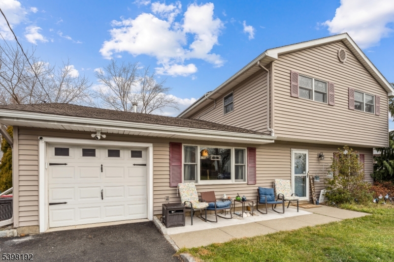 a front view of house with yard patio and outdoor seating