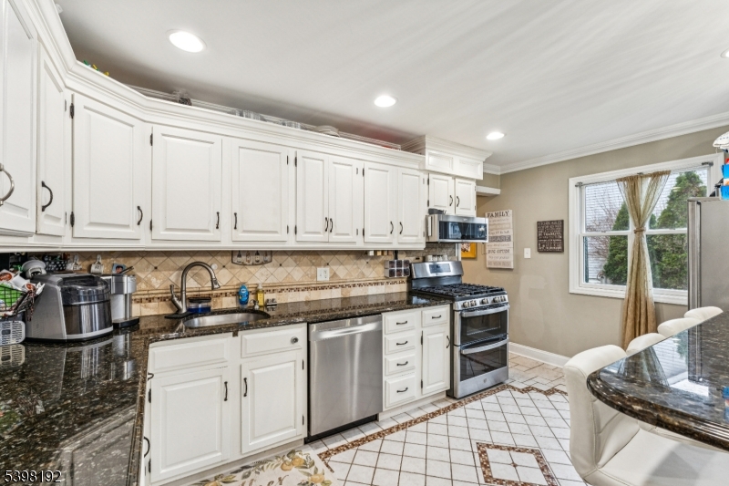 7 Overbrook Road Flanders, NJ 07836 - Photo 9 of 32 a kitchen with stainless steel appliances granite countertop a stove sink and cabinets