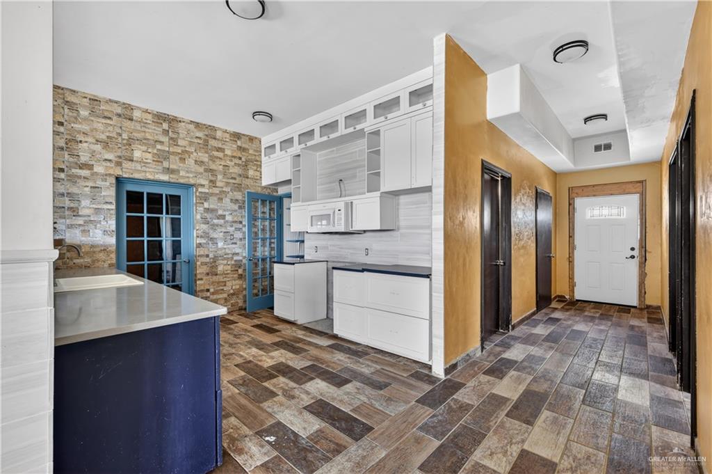 1424 North Sky Soldier Road Weslaco, TX 78596 - Photo 13 of 33 a view of a kitchen cabinets and wooden floor