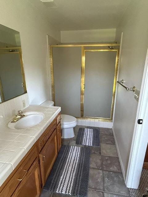 3046 Cypress Avenue Clovis, CA 93611 - Photo 36 of 48 a bathroom with a granite countertop shower a sink and toilet