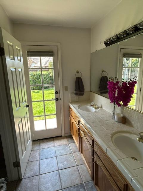 3046 Cypress Avenue Clovis, CA 93611 - Photo 37 of 48 a bathroom with a sink a vanity and a mirror