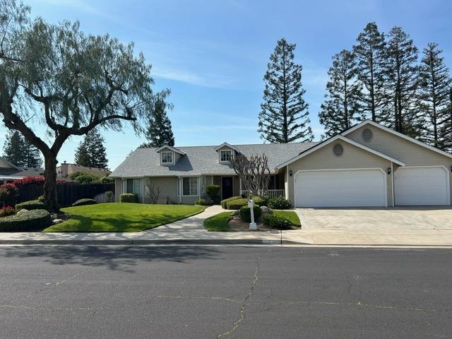 3046 Cypress Avenue Clovis, CA 93611 - Photo 4 of 48 a house that has a tree in front of it