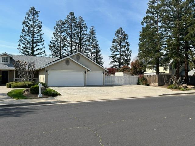 3046 Cypress Avenue Clovis, CA 93611 - Photo 5 of 48 a front view of a house with a yard and garage