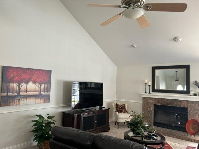 3046 Cypress Avenue Clovis, CA 93611 - Photo 6 of 48 a living room with furniture a fireplace and a flat screen tv