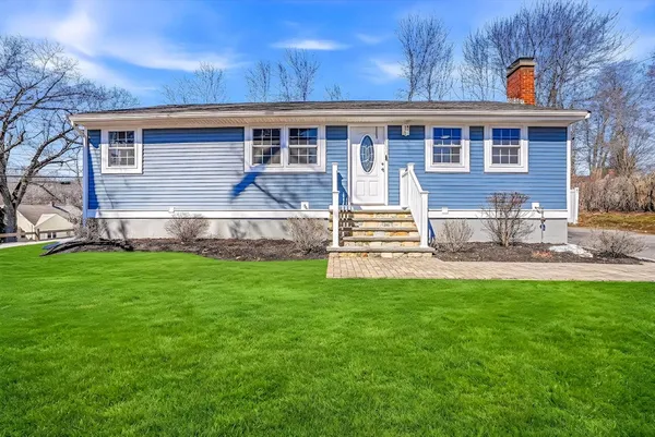 a view of a house with backyard and a garden