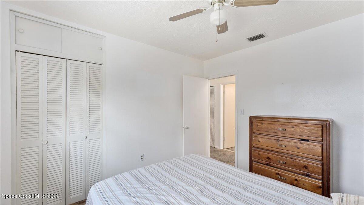 2914 Stetson Street Melbourne, FL 32901 - Photo 14 of 22 a bedroom with a bed and a dresser