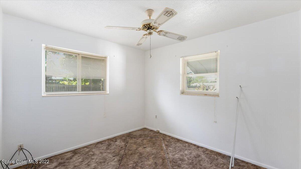 2914 Stetson Street Melbourne, FL 32901 - Photo 17 of 22 an empty room with a window and ceiling fan