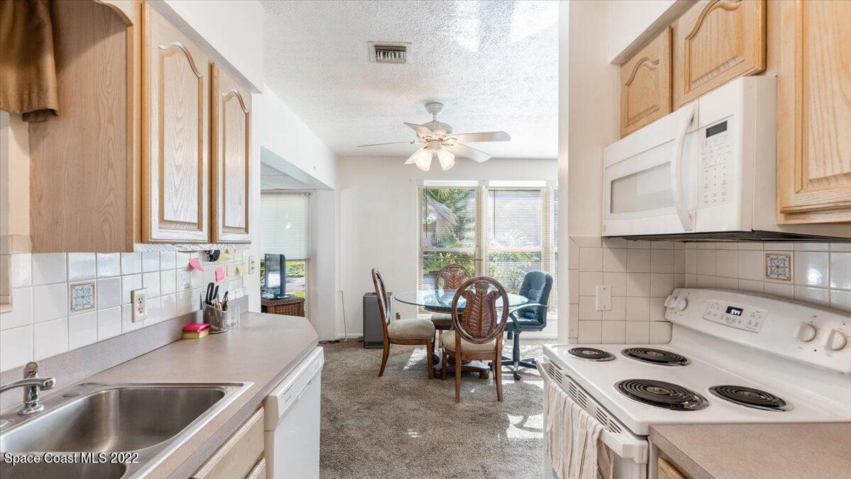 2914 Stetson Street Melbourne, FL 32901 - Photo 9 of 22 a kitchen with a sink a stove and cabinets