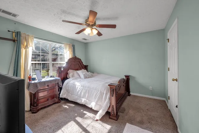 a bedroom with a bed and window