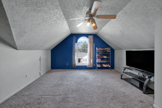 en empty room with windows and fan