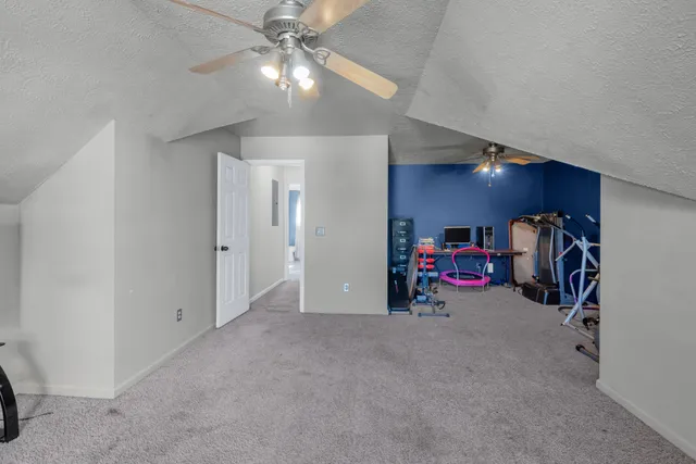 a view of a livingroom with furniture and a ceiling fan