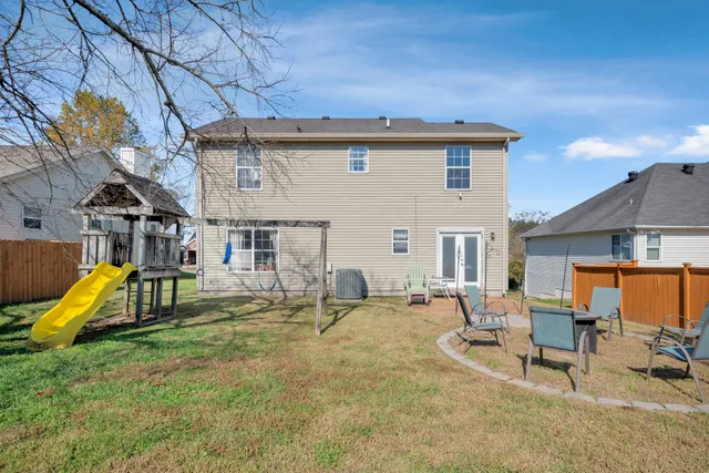 a view of a house with swimming pool and sitting area