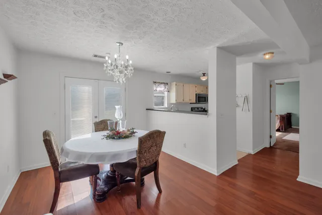 a dining room with furniture and wooden floor