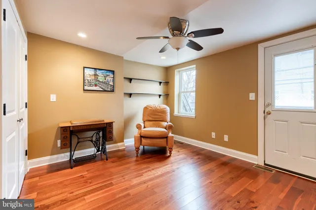 a workspace with wooden floor and a ceiling fan