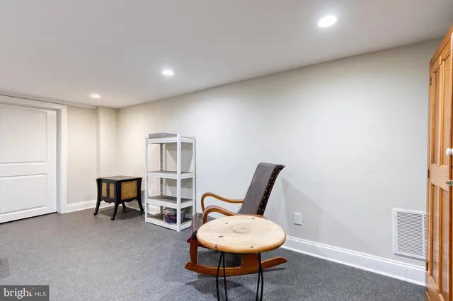 a living room with furniture a piano and a window