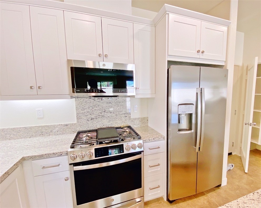 35 Bedford Court Arcadia, CA 91007 - Photo 2 of 15 a kitchen with stainless steel appliances granite countertop a stove a refrigerator and a granite counter tops