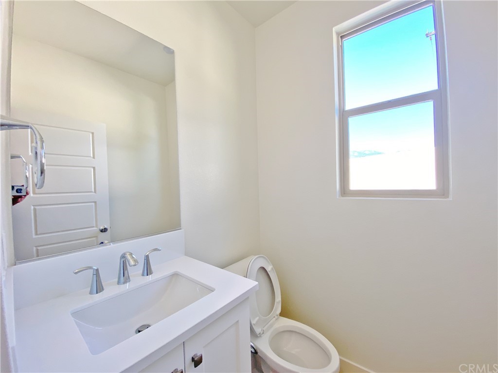 35 Bedford Court Arcadia, CA 91007 - Photo 7 of 15 a bathroom with a toilet sink vanity and mirror