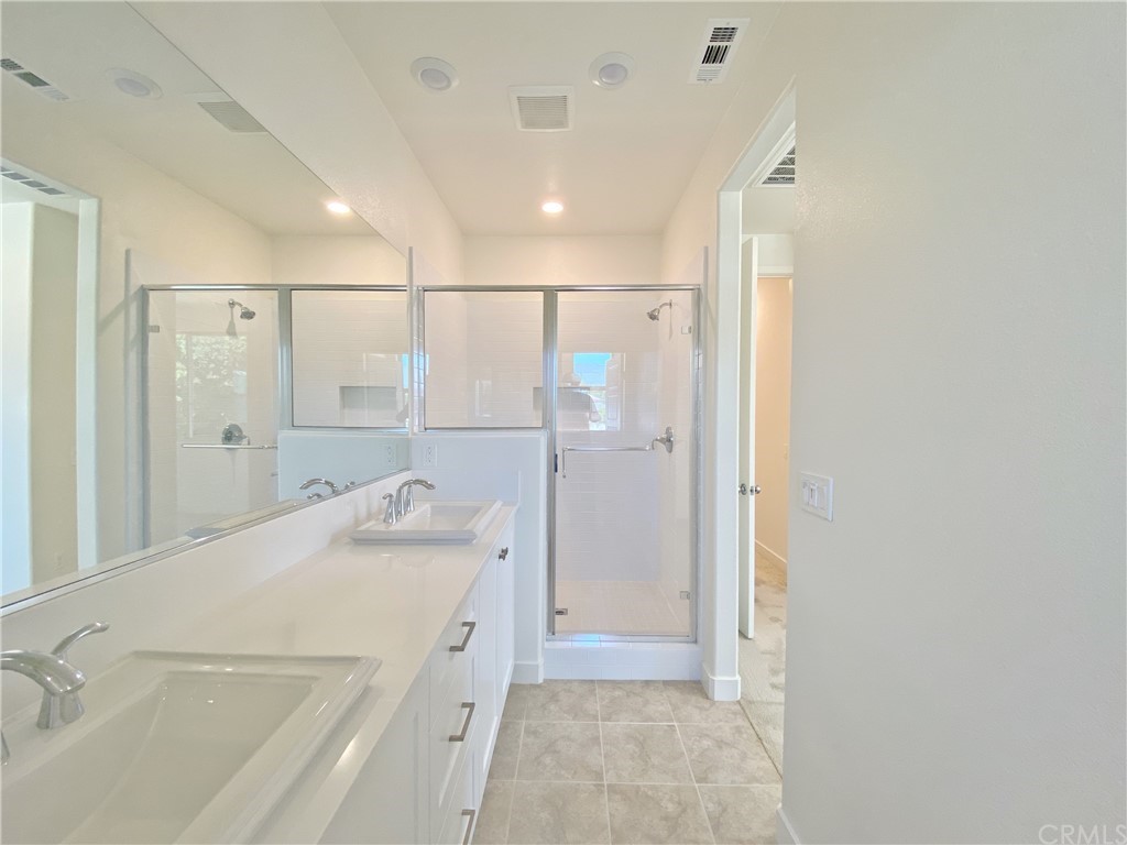 35 Bedford Court Arcadia, CA 91007 - Photo 10 of 15 a bathroom with a sink a granite counter and a shower
